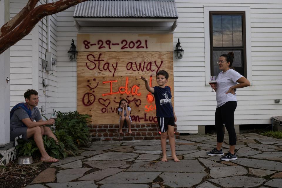 Jean-Luc Bourg, 8, his sister Olivia, 10, and parents Jean Paul and Christina have boarded up their property in preparation for Hurricane Ida in Morgan City, Louisiana (REUTERS)