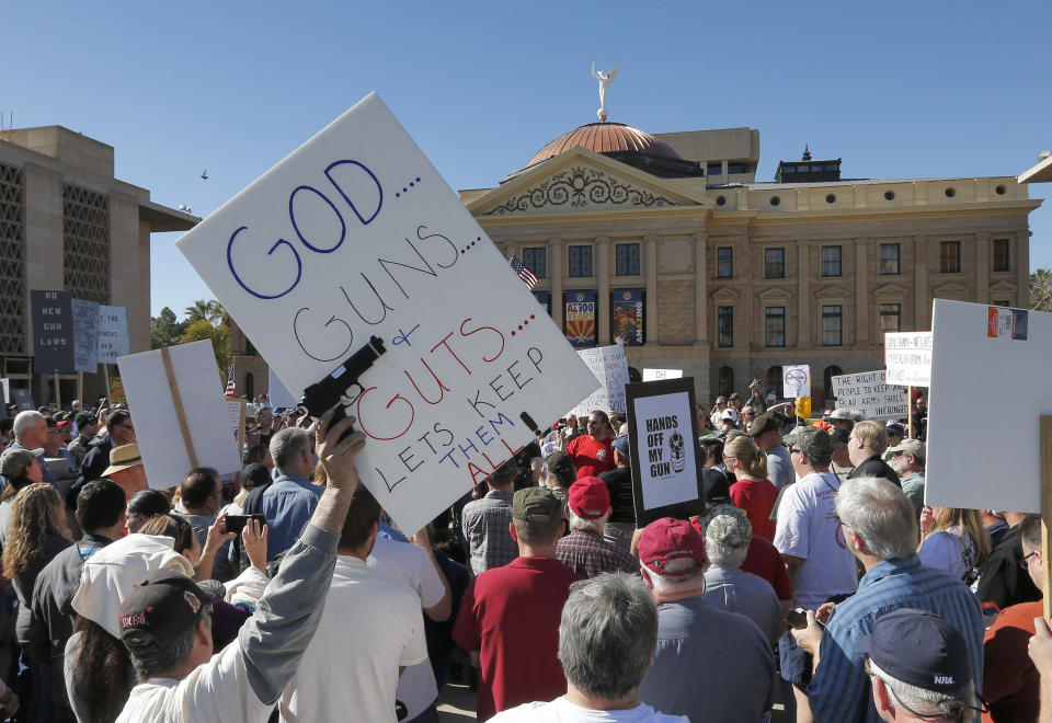 FILE - Gun rights supporters stand outside the Capitol in Phoenix on Saturday, Jan. 19, 2013, during a Guns Across America rally. The nationwide rally was in support of the Second Amendment and called for no new gun laws. After a gunman killed 19 children and two teachers at an elementary school in Uvalde, Texas, on May 24, 2022, several pastors and rabbis around the country have challenged their conservative counterparts with this question: Are you pro-life if you are pro-guns? (AP Photo/Matt York, File)