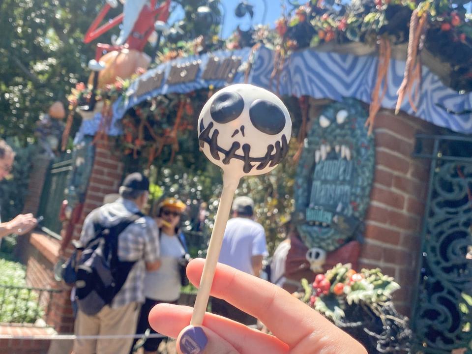 hand holding jack skellington cake pop at disneyland