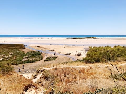 There are stunning beaches beside Tavira - Credit: GETTY