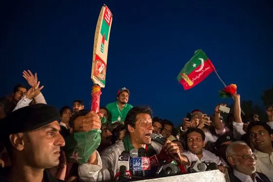 Khan waves a cricket bat, the election symbol of his PTI party, during a rally in Faisalabad on May 5, 2013.<span class="copyright">Daniel Berehulak—Getty Images</span>
