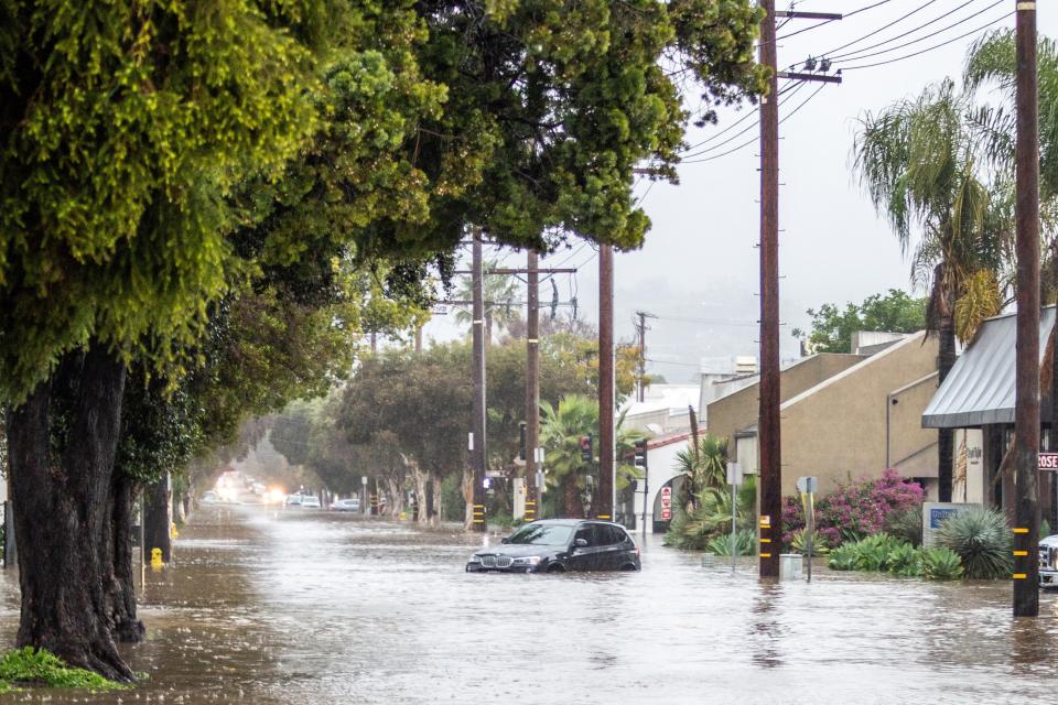 Abandoned cars are left in a flooded street in Santa Barbara earlier this week (REUTERS)