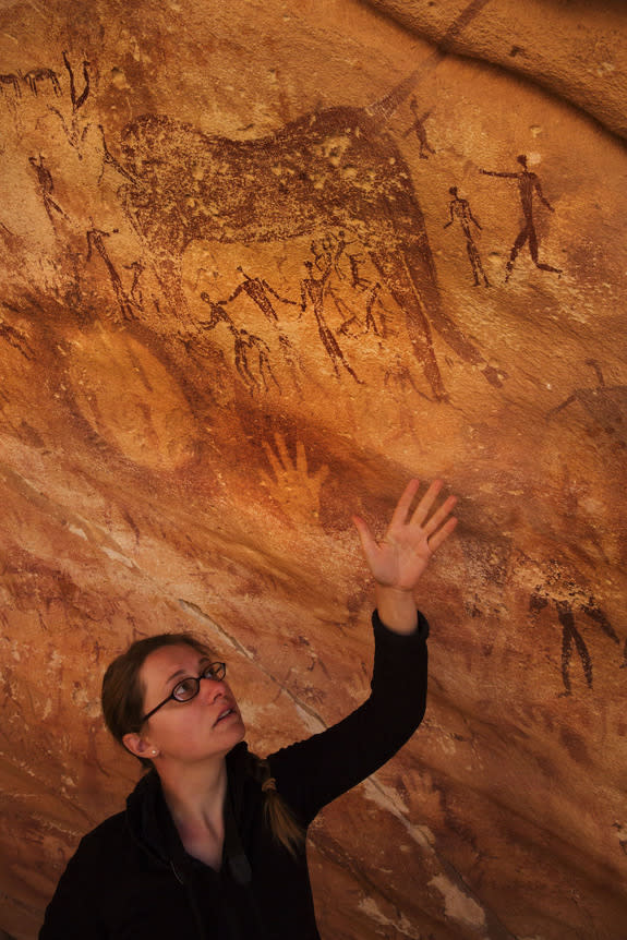 Emmanuelle Honoré holds up her hand in the Wadi Su?ra II cave, located in the Egyptian part of the Libyan Desert.