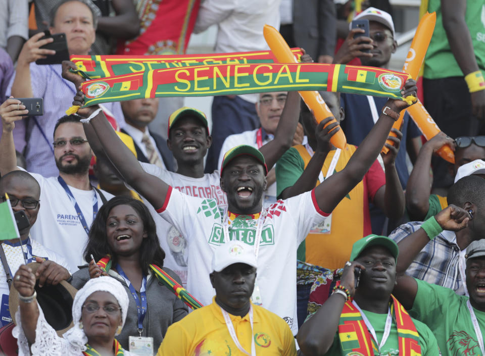 Senegal fans cheer before the African Cup of Nations semifinal soccer match between Senegal and Tunisia in 30 June stadium in Cairo, Egypt, Sunday, July 14, 2019. (AP Photo/Hassan Ammar)