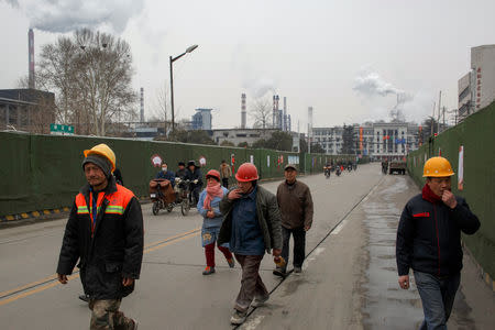 Workers walk outside a steel plant in Anyang, Henan province, China, February 18, 2019. Picture taken February 18, 2019. REUTERS/Thomas Peter