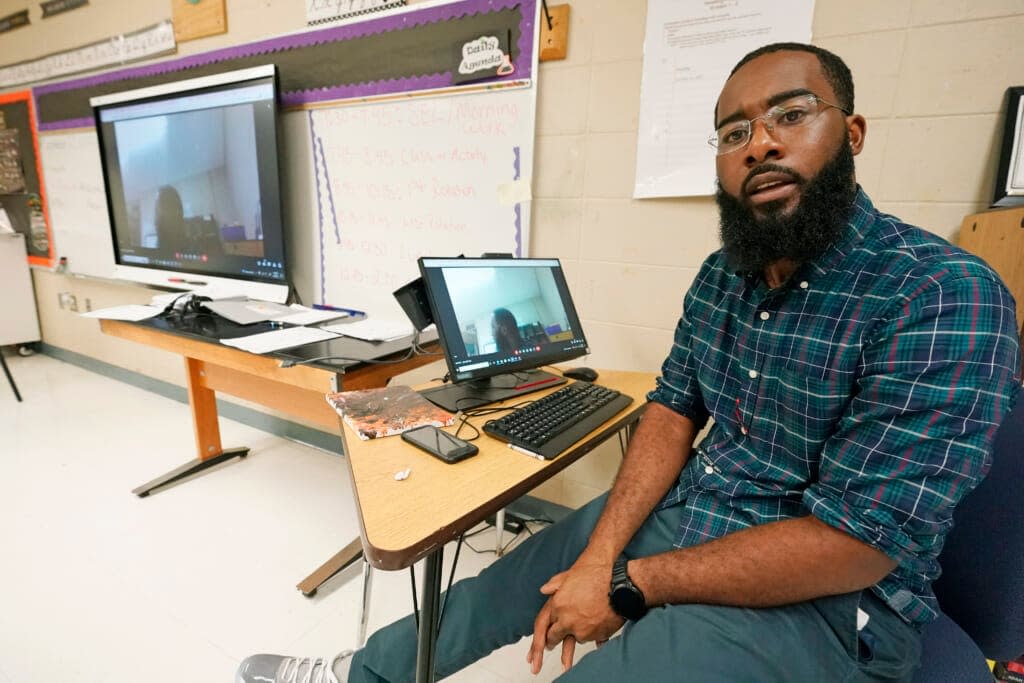 Ryan Johnson, a fifth-grade teacher at Pecan Park Elementary School, speaks about the challenges of remote learning for himself and his daughter while in his classroom in Jackson, Miss., Tuesday, Sept. 6, 2022. (AP Photo/Rogelio V. Solis)