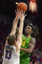 Oregon forward C.J. Walker (14) shoots over Arizona forward Stone Gettings during the first half of an NCAA college basketball game Saturday, Feb. 22, 2020, in Tucson, Ariz. (AP Photo/Rick Scuteri)