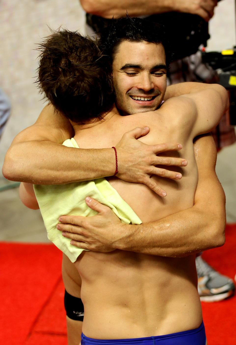 DELHI, INDIA - OCTOBER 11: Alexandre Despatie (R) of Canada celebrates teammate Eric Sehn after winning the gold medal in the Men's 3m Springboard Final at Dr. S.P. Mukherjee Aquatics Complex during day eight of the Delhi 2010 Commonwealth Games on October 11, 2010 in Delhi, India. (Photo by Matt King/Getty Images)