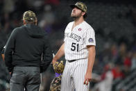 Colorado Rockies relief pitcher Ben Bowden waits to be pulled from the mound after he issued a walk to Cincinnati Reds' Jonathan India during the 11th inning of a baseball game Saturday, May 15, 2021, in Denver. (AP Photo/David Zalubowski)