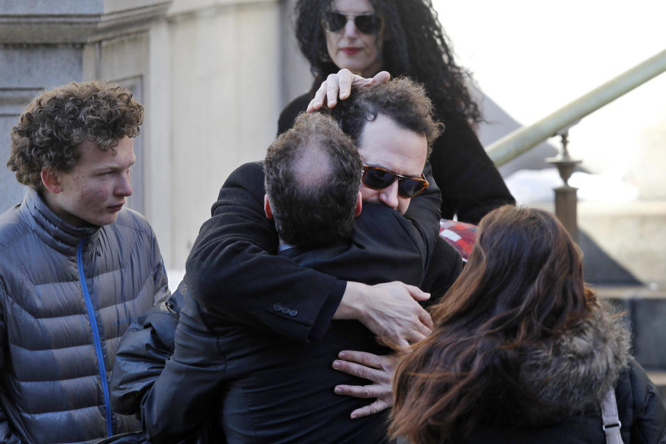 Writer David Bar Katz is embraced as he arrives at the Church of St. Ignatius Loyola for the private funeral of actor Philip Seymour Hoffman Friday, Feb. 7, 2014, in New York. Hoffman, 46, was found dead Sunday of an apparent heroin overdose. (AP Photo/Jason DeCrow)