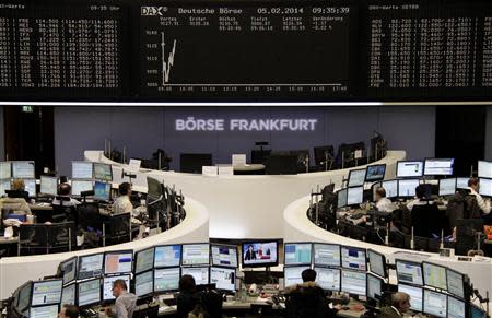 Traders are pictured at their desks in front of the DAX board at the Frankfurt stock exchange February 5, 2014. REUTERS/Remote/Stringer