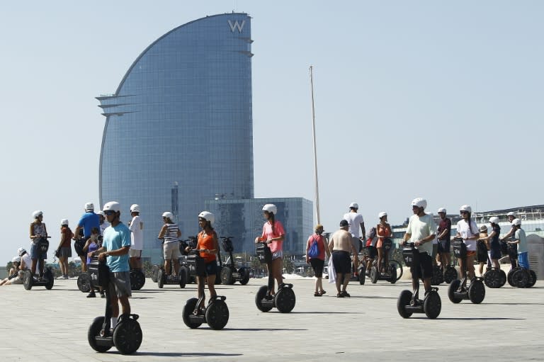 A group of tourists enjoy a Segway tour in La Barceloneta suburb of Barcelona