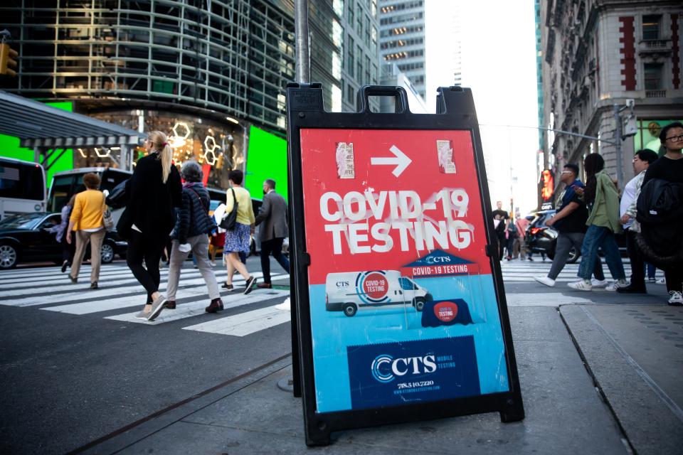 NEW YORK, USA - MAY 12: Pedestrians pass a sign advertising a COVID-19 testing site in New York, the United States, on May 12, 2022.  TO GO WITH 