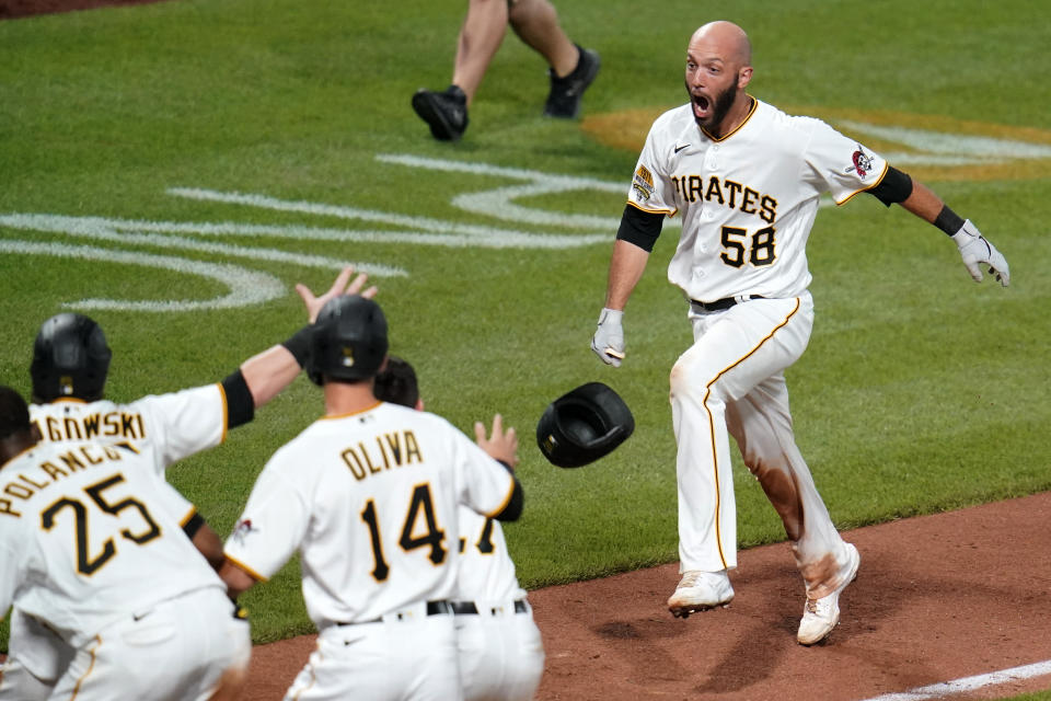 Pittsburgh Pirates' Jacob Stallings , right,celebrates as he rounds the bases after hitting a walkoff grand slam off New York Mets relief pitcher Edwin Diaz during the ninth inning of a baseball game in Pittsburgh, Saturday, July 17, 2021. (AP Photo/Gene J. Puskar)