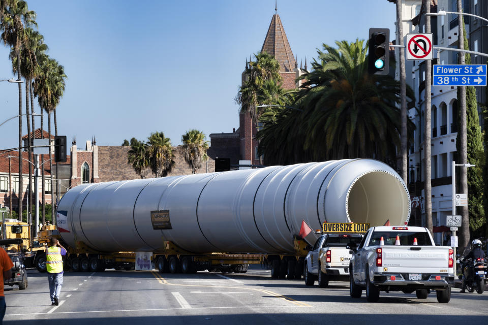 One of two rocket motors are slowly turned into the receiving area of the California Science Center upon their arrival in Los Angeles, Wednesday Oct. 11, 2023. The giant rocket motors, required to display the retired NASA space shuttle Endeavour as if it’s about to blast off, were trucked over two days from Mojave Air and Space Port to LA’s Exposition Park, where the California Science Center’s Samuel Oschin Air and Space Center is being built to display Endeavour. (AP Photo/Richard Vogel)