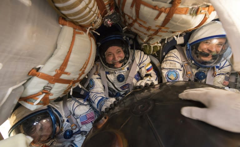 Expedition 52 Flight Engineer Peggy Whitson (L), Commander Fyodor Yurchikhin of Roscosmos (C) and Fight Engineer Jack Fischer of NASA are seen inside the Soyuz MS-04 spacecraft shortly after it landed near the town of Zhezkazgan, Kazakhstan