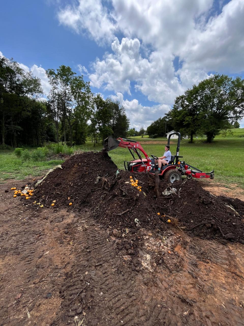 Green Heron Composting Service staff member Kelly Newby manages a compost pile at the company’s farm location in Madisonville, Tenn. 2021