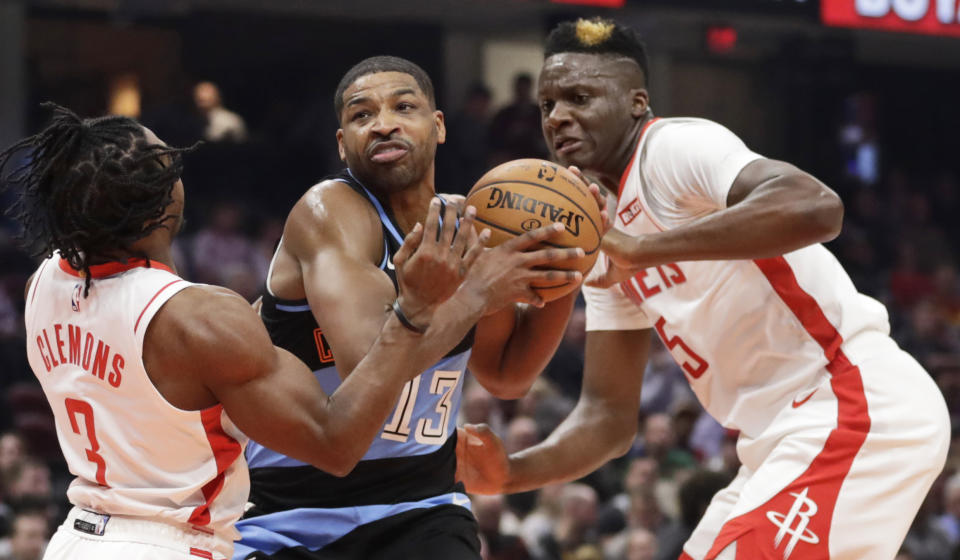 Cleveland Cavaliers' Tristan Thompson, center, drives between Houston Rockets' Chris Clemons, left, and Clint Capela in the first half of an NBA basketball game, Wednesday, Dec. 11, 2019, in Cleveland. (AP Photo/Tony Dejak)