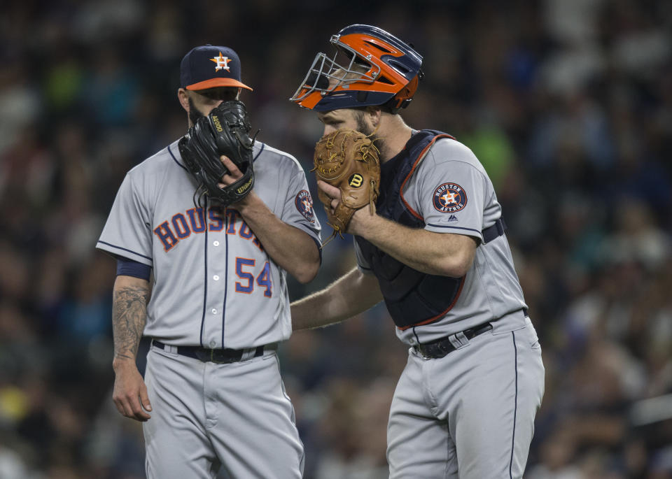 Evan Gattis (right) and Mike Fiers during happier times in 2016. (Photo by Stephen Brashear/Getty Images)