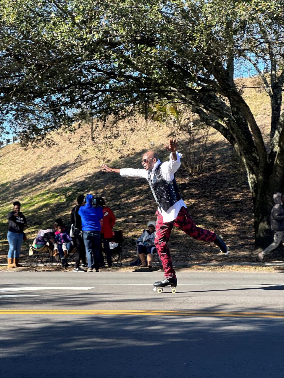 A man skates down Martin Luther King Jr. Boulevard as part of parade celebrations.