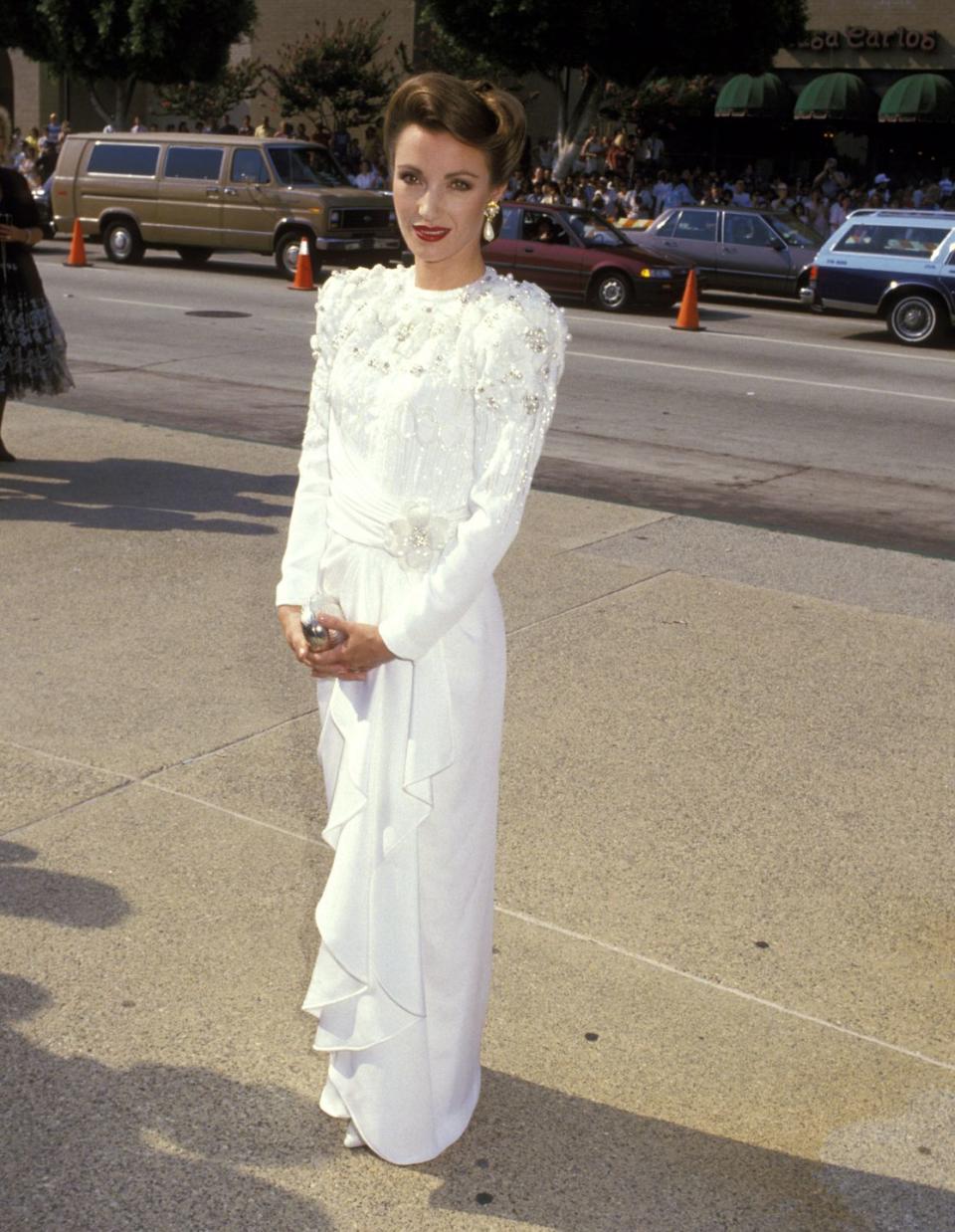 <p>The British star wore her hair up with a retro wave, and opted for a white long-sleeve embellished gown with a ruffled skirt. </p>