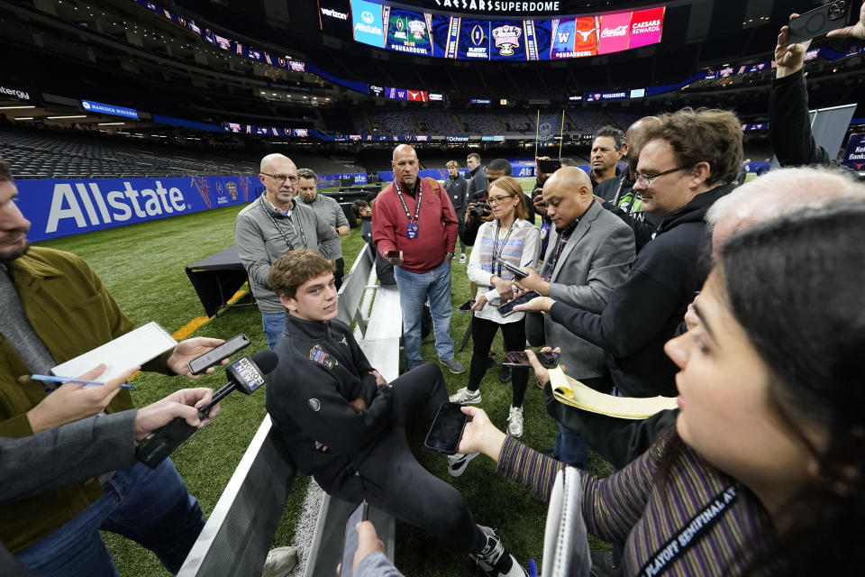 Texas quarterback Arch Manning talks to reporters during media day for the the upcoming Sugar Bowl NCAA college football semi-final game in New Orleans, Saturday, Dec. 30, 2023. (AP Photo/Gerald Herbert)