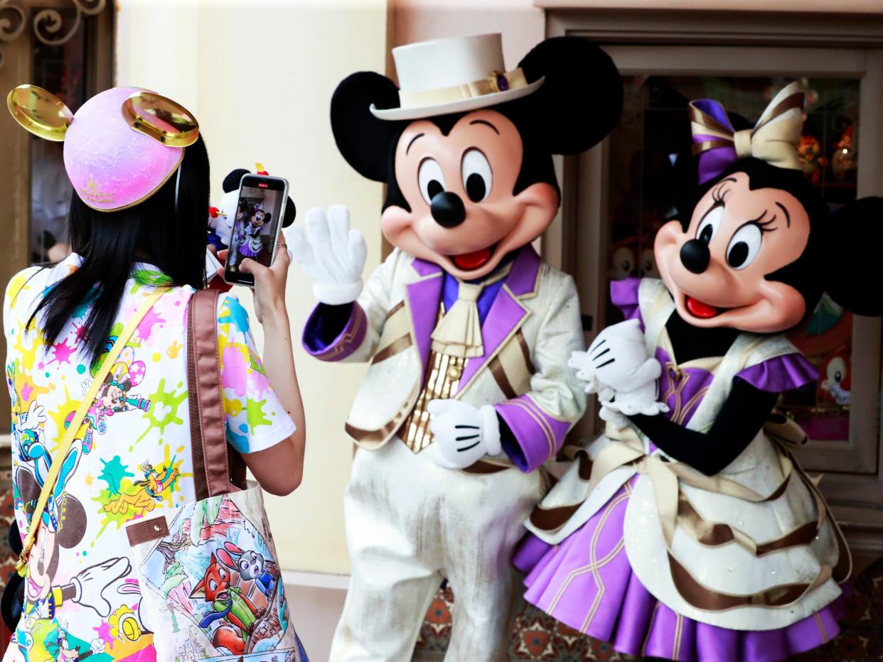 A picture of Mickey and Minnie Mouse actors.