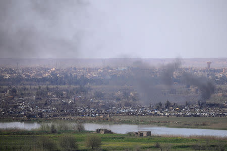 Smoke rises from the last besieged neighborhood in the village of Baghouz, Deir Al Zor province, Syria March 20, 2019. Picture taken March 20, 2019. REUTERS/Rodi Said