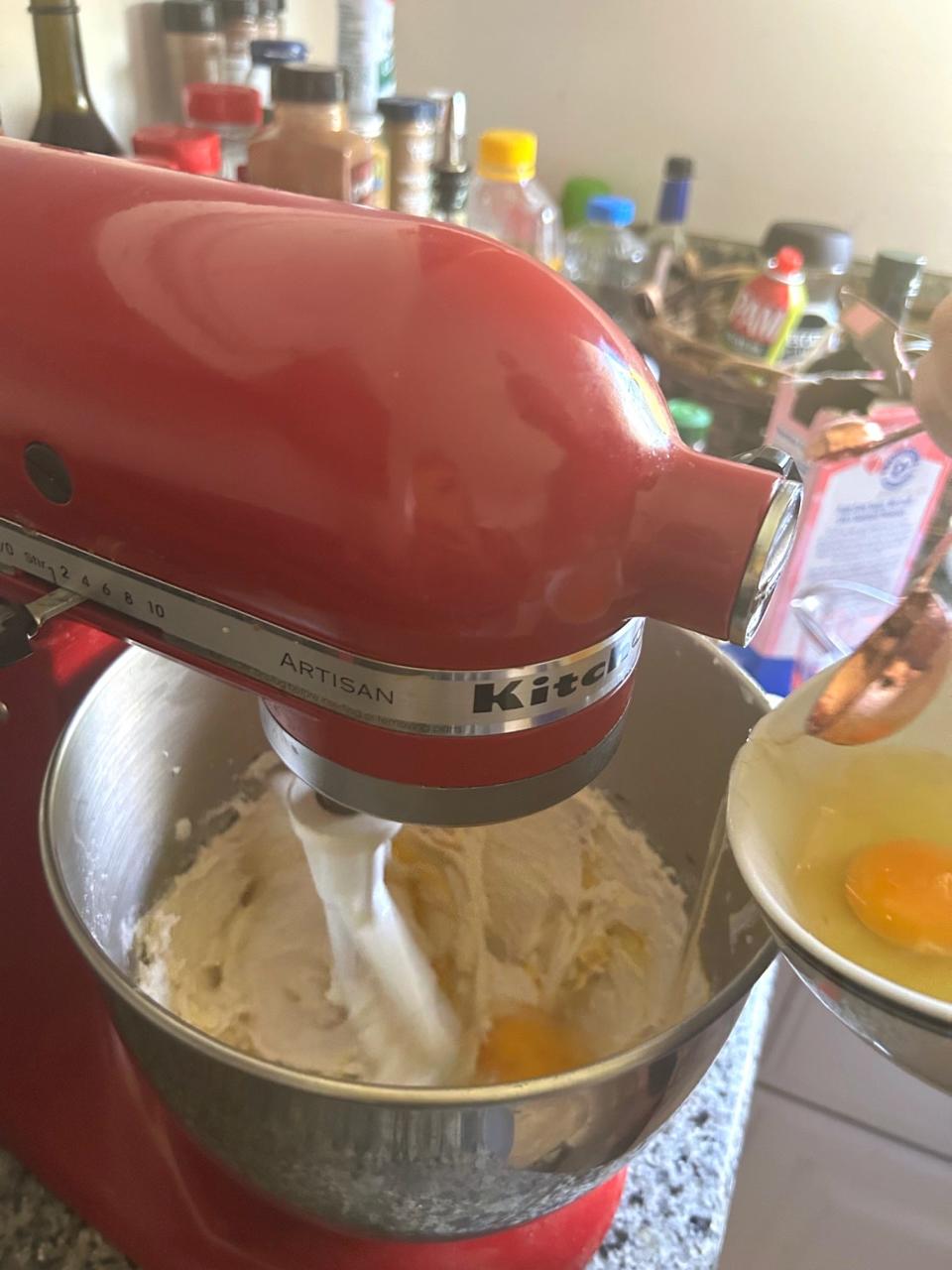 Adding eggs to Ina Garten's chocolate cake with mocha frosting