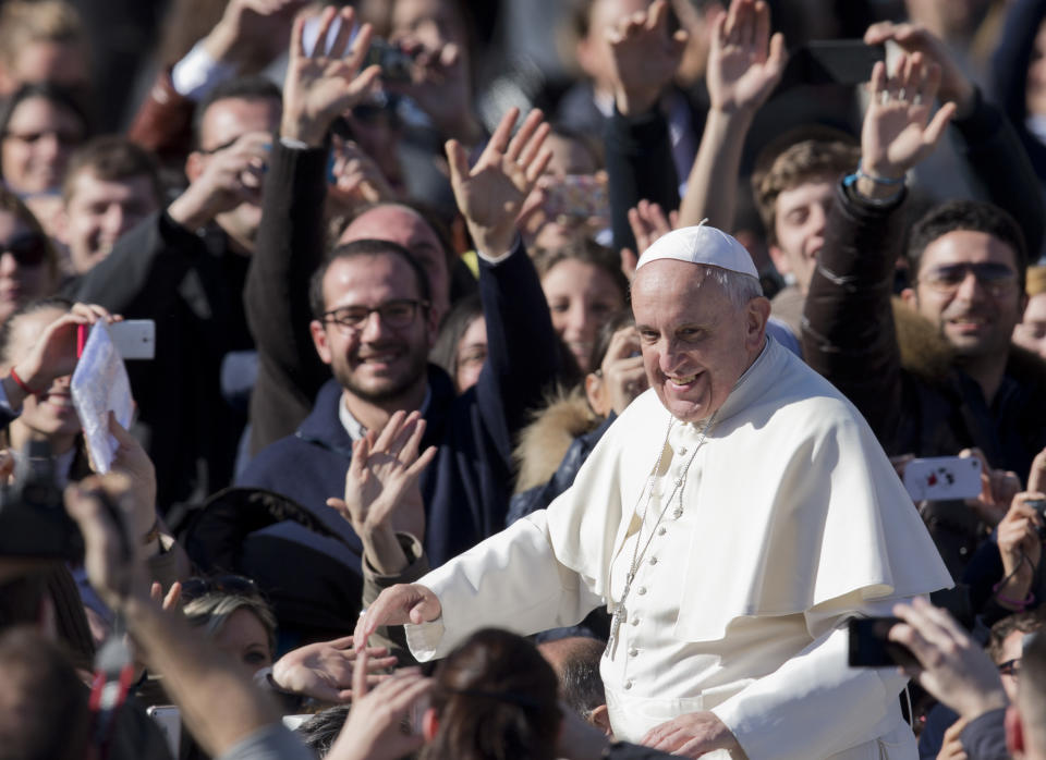 Pope Francis greets faithful as he leaves St. Peter's Square at the Vatican, Friday, Feb. 14, 2014. Pope Francis met a group of engaged couples on Valentine's Day. (AP Photo/Alessandra Tarantino)