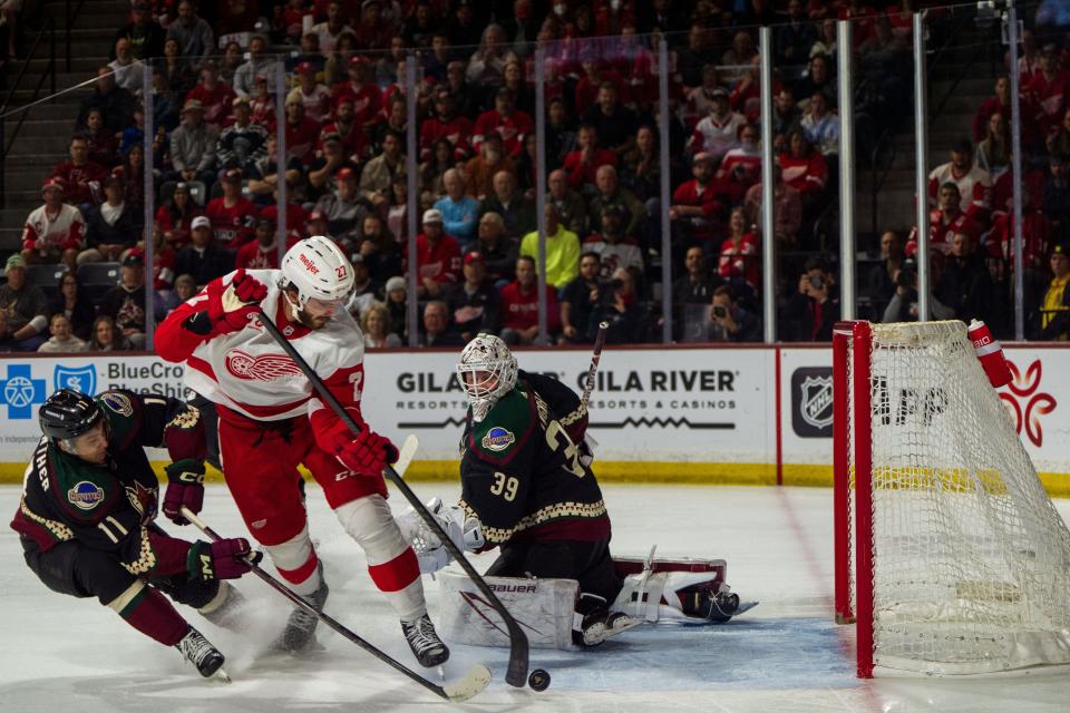 Detroit Red Wings forward Dylan Larkin (71) after a breakaway is unable to score against Arizona Coyotes forward Dylan Guenther (11) and goalie Connor Ingram (39) in the first period at Mullett Arena.