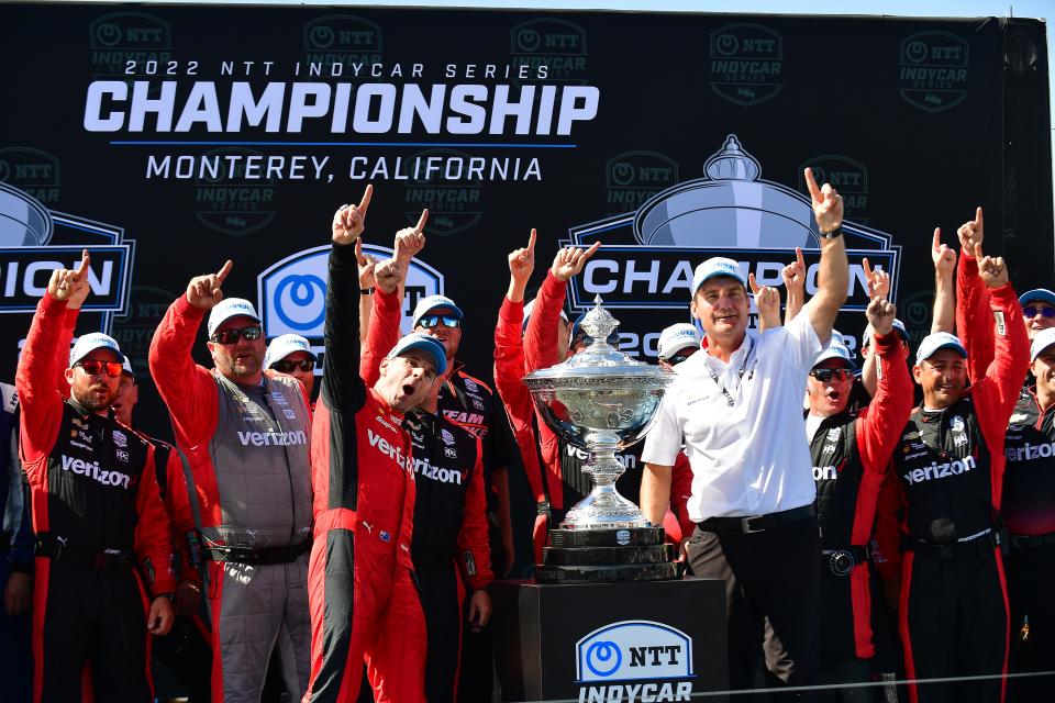 Sep 11, 2022; Salinas, California, USA; Team Penske driver Will Power (12) of Australia celebrates his series victory with crew and team president Tim Cindric following the Grand Prix of Monterey at WeatherTech Raceway Laguna Seca.