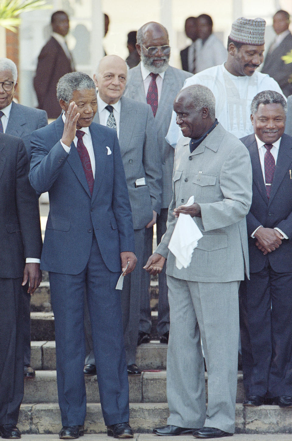 FILE - In this Feb. 28, 1990 file photo, South Africa's Nelson Mandela, left, joins Zambia President Kenneth Kaunda in Lusaka, after meeting with seven African Presidents and commonwealth leaders. Zambia’s first president Kenneth Kaunda has died at the age of 97, the country's president Edward Lungu announced Thursday June 17, 2021. (AP Photo/John Parkin, File)
