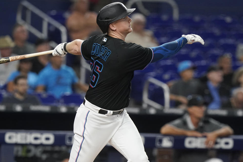 Miami Marlins' Garrett Cooper (26) watches his two-run home run during the first inning of the team's baseball game against the New York Mets, Friday, Sept. 9, 2022, in Miami. (AP Photo/Marta Lavandier)