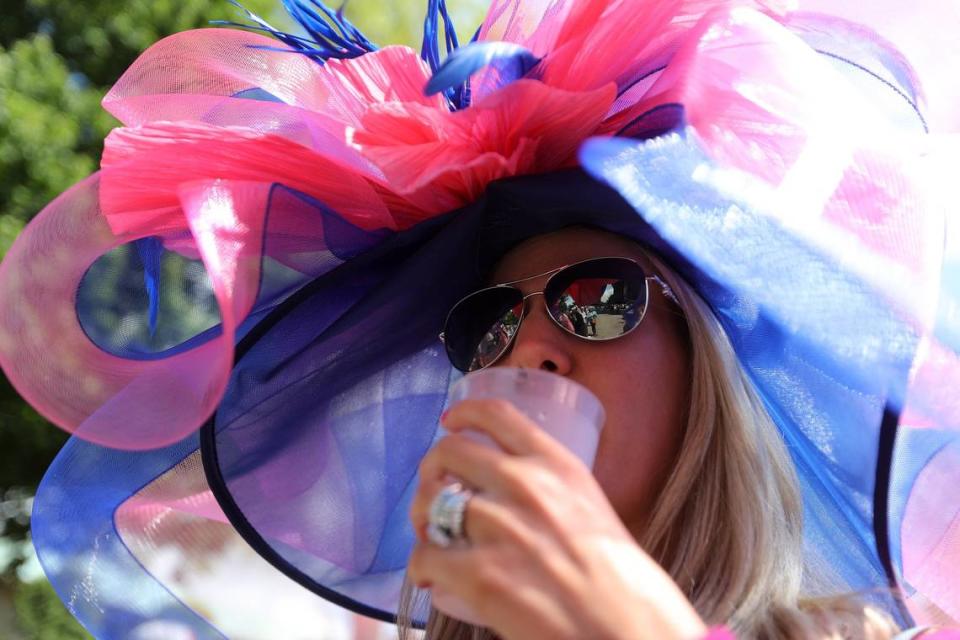 Heather Clark of Frankfort sips her drink on Kentucky Derby day at Keeneland Race Course in Lexington, Ky., Saturday, May 6, 2017.