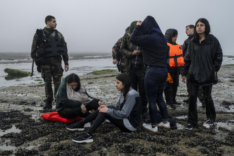 A group of Kurdish migrants from Iran and Iraq who failed in their attempt to reach the United Kingdom by boat rest on the beach of Ambleteuse, northern France, on Sunday, May 19, 2024 after being discovered by the police. (AP Photo/Bernat Armangue)