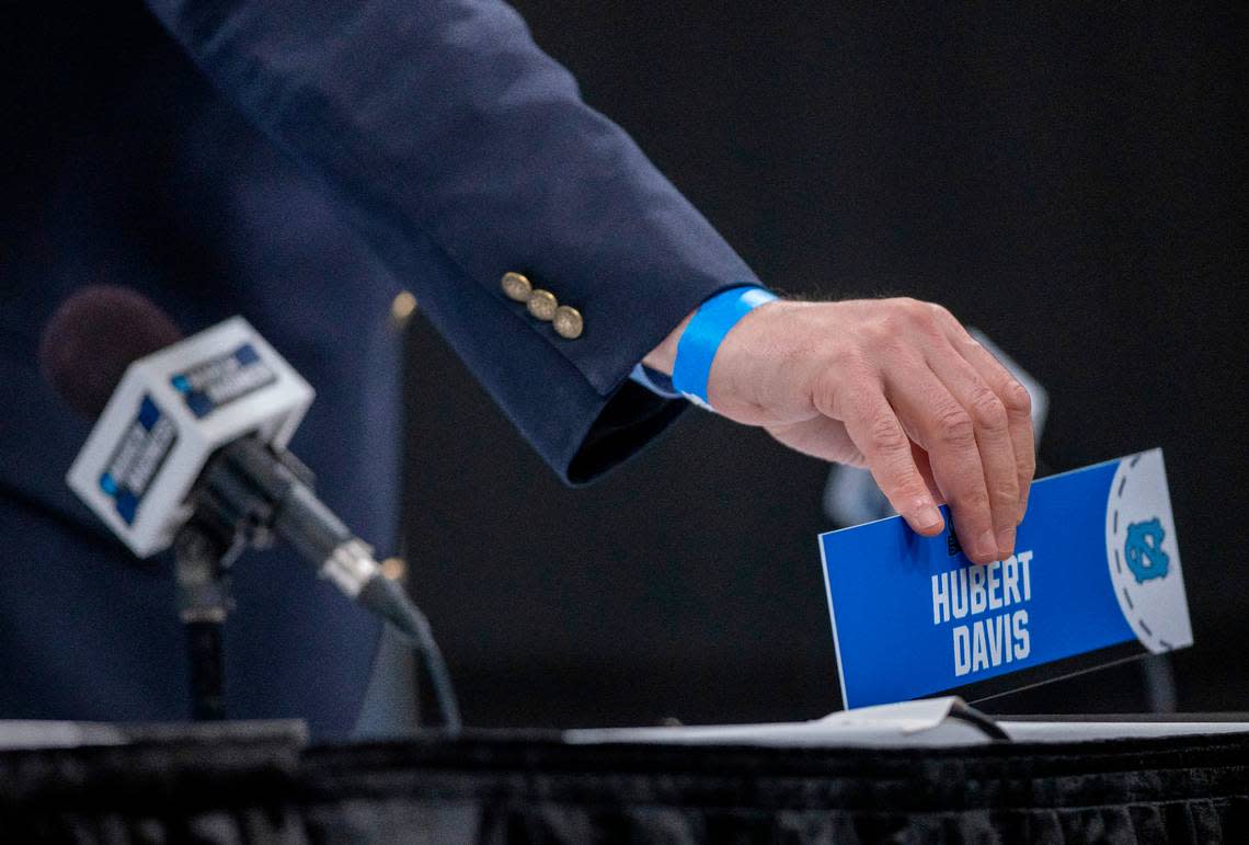 Moderator Phil Warshauer positions a name plate for North Carolina coach Hubert Davis on dais prior to his arrival for media availability for the NCAA Tournament on Wednesday, March 20, 2024 at Spectrum Center in Charlotte, N.C. Robert Willett/rwillett@newsobserver.com