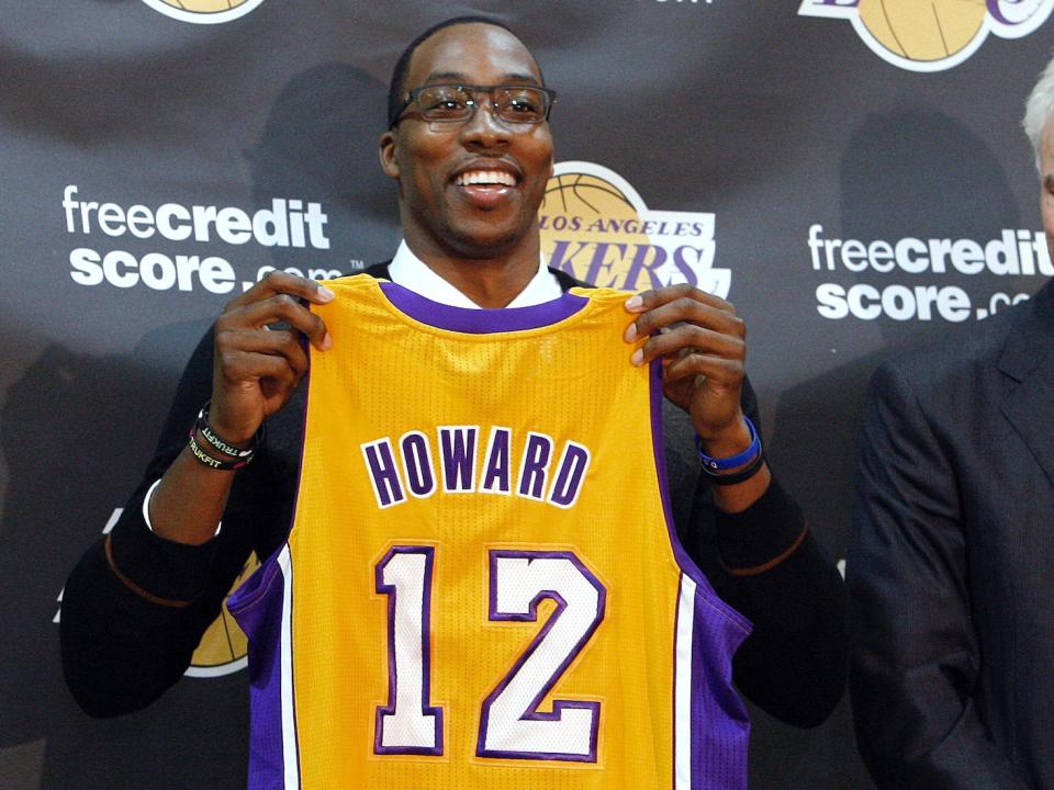 Dwight Howard holds up his Lakers jersey at his introductory press conference in 2012.