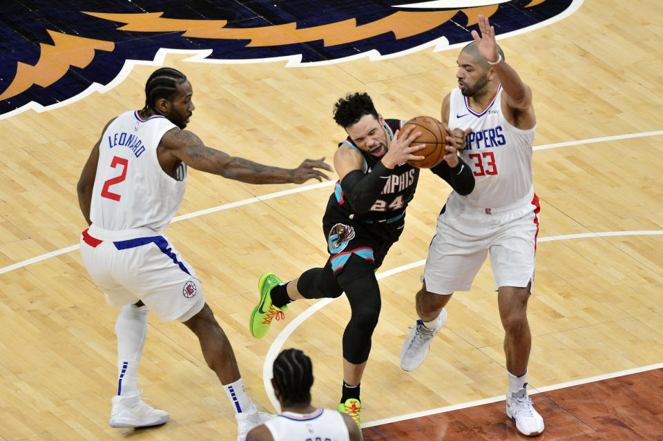 Memphis Grizzlies guard Dillon Brooks (24) handles the ball between Los Angeles Clippers forwards Kawhi Leonard (2) and Nicolas Batum (33) in the first half of an NBA basketball game Thursday, Feb. 25, 2021, in Memphis, Tenn. (AP Photo/Brandon Dill)