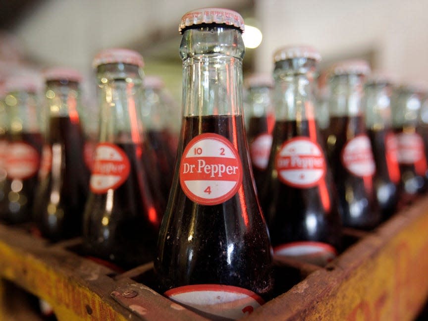 A crate of Dr Pepper bottles with a vintage logo.