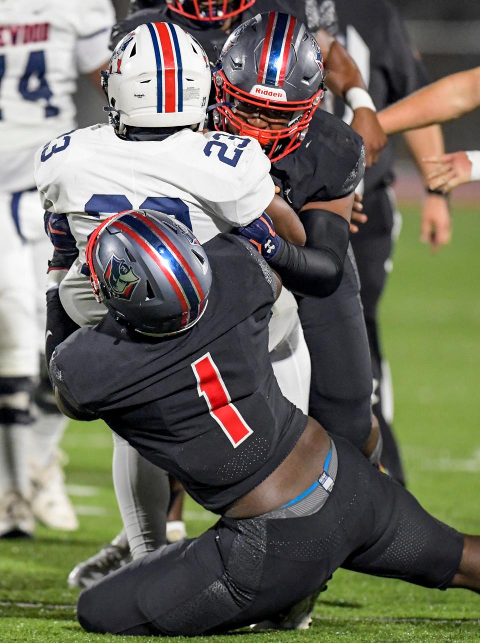 Pike Road's Malik Blocton(1) and Gavan Rodgers (44) tackle Homewood's Altovise Crear (23) during an AHSAA first round high school football playoff game in Pike Road, Ala., on Friday November 10, 2023.
