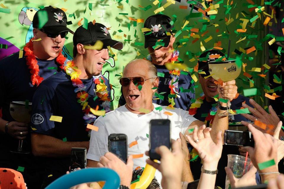 LAS VEGAS, NV - OCTOBER 14:  Recording artist Jimmy Buffett (C) stands with members of the Wounded Warrior Amputee Softball Team as he toasts the crowd during the grand opening celebration for the Margaritaville Casino at Flamingo Las Vegas October 14, 2011 in Las Vegas, Nevada. The casino set the Guinness World Records title for largest gallon beverage with an 8,500-gallon, two-story Margarita named 