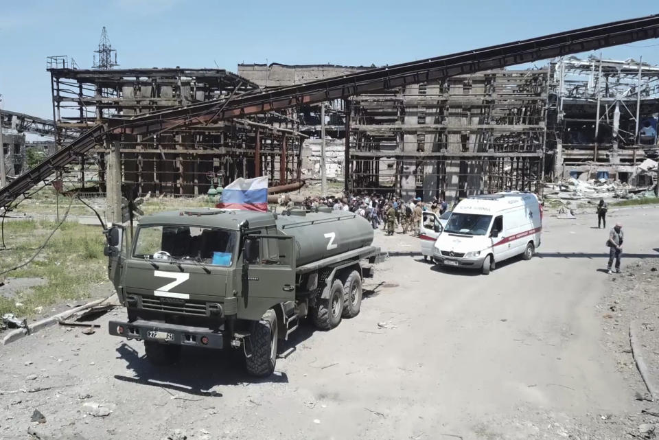 In this photo taken from video released by the Russian Defense Ministry on Monday, June 13, 2022, Russian military vehicle stand next to the Metallurgical Combine Azovstal plant, in Mariupol, on the territory which is under the Government of the Donetsk People's Republic control, eastern Ukraine. The plant was almost completely destroyed during the siege of Mariupol. (Russian Defense Ministry Press Service via AP)