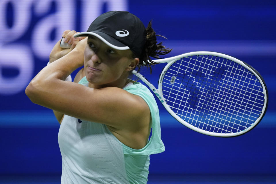 Iga Swiatek, of Poland, returns a shot against Jessica Pegula, of the United States, during the quarterfinals of the U.S. Open tennis championships, Wednesday, Sept. 7, 2022, in New York. (AP Photo/Julia Nikhinson)