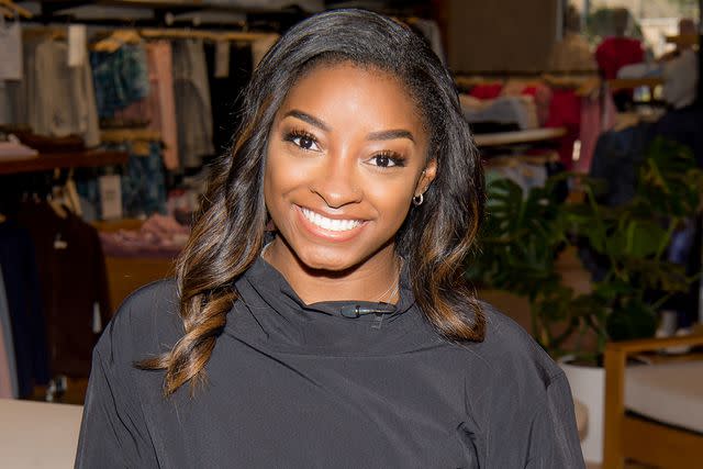 <p>Marcus Ingram/Getty Images</p> Simone Biles during the AthletaWell Gold Medal Groove at Athleta Town & Country Village