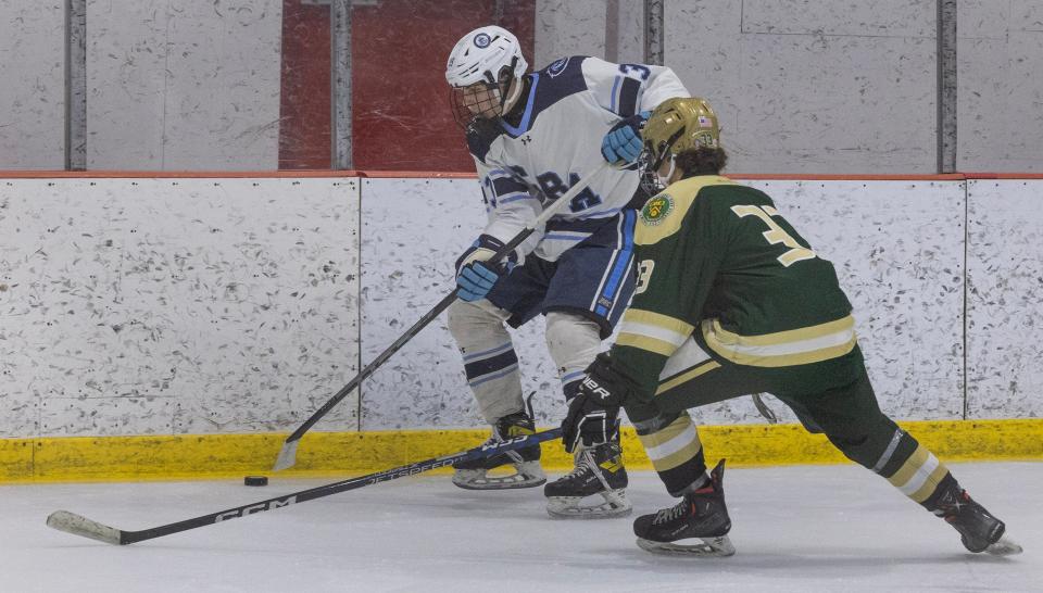 CBA Jack Skorupka and St.Joe Landon Albano battle for puck in early action. Christian Brothers Academy hockey dominates St. Joseph’s Montvale in game on February 22, 2023 in Wall, NJ. 