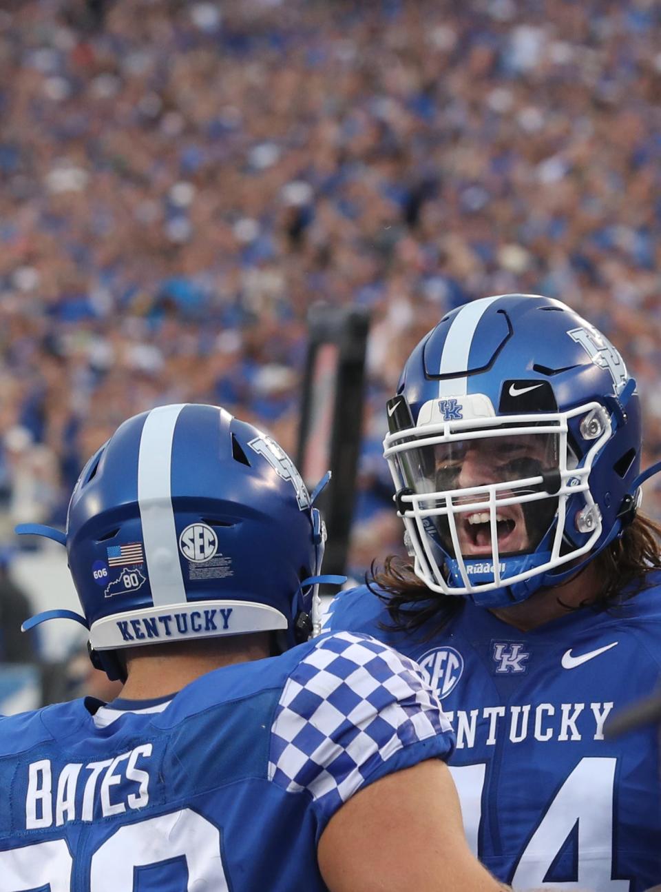 Kentucky’s Brenden Bates celebrates scoring a touchdown with teammate David Wohlabaugh in the 1st quarter against Miami of Ohio.Sept. 3, 2022