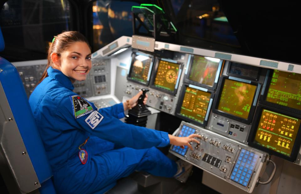 Alyssa Carson in the replica cockpit of a space shuttle at the Atlantis exhibit at Kennedy Space Center Visitor Complex. Carson, 18-year-old Florida Tech student, has known she wanted to be an astronaut from a very young age and has been working towards that goal since childhood.