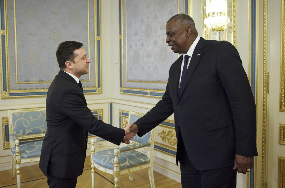 Ukrainian President Volodymyr Zelenskyy, left, shakes hands with U.S. Defense Secretary Lloyd Austin during their meeting in Kyiv, Ukraine, Tuesday, Oct. 19, 2021. (Ukrainian Presidential Press Office via AP)