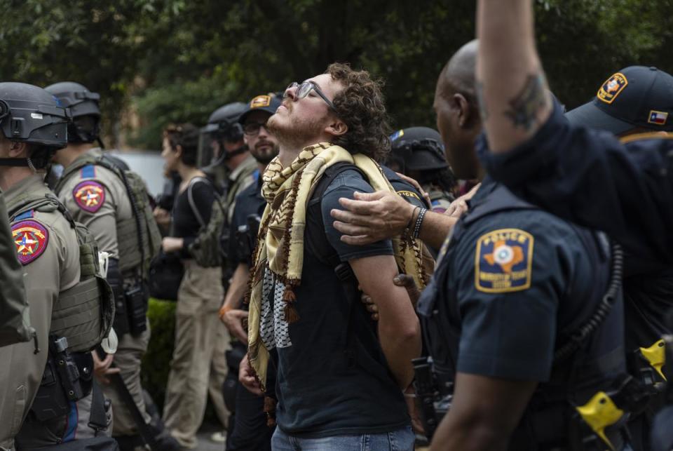 A protestor is detained by University of Texas Police during a student demonstration in support of Palestine on the University of Texas campus Wednesday, April 24, 2024, in Austin.